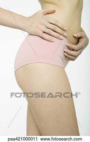 Young woman wearing underwear, hands on waist, close-up of mid section View Large Photo Image Stock Image - Young woman wearing underwear, hands on waist, close-up of mid section. Fotosearch