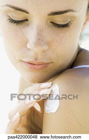 Woman applying sunscreen to shoulder, close-up View Large Photo Image Stock Photo - Woman applying sunscreen to shoulder, close-up. Fotosearch