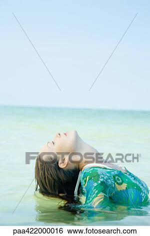 Woman in sea, bending head back View Large Photo Image Stock Photograph - Woman in sea, bending head back . Fotosearch