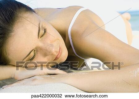 Woman lying on beach, close-up View Large Photo Image Stock Image - Woman lying on beach, close-up. Fotosearch