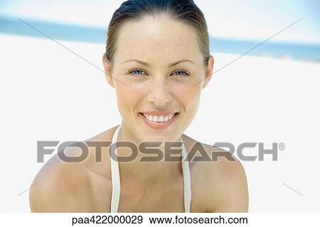 Woman on beach, smiling at camera, head and shoulders View Large Photo Image Stock Photo - Woman on beach, smiling at camera, head and shoulders. Fotosearch