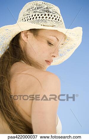 Woman wearing straw hat, low angle view View Large Photo Image Stock Photo - Woman wearing straw hat, low angle view. Fotosearch