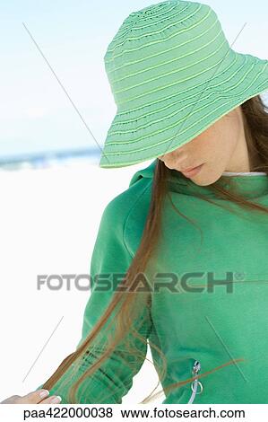 Woman wearing sunhat on beach, looking down View Large Photo Image Stock Photo - Woman wearing sunhat on beach, looking down. Fotosearch