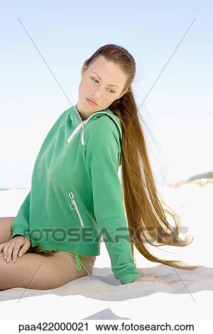 Woman with long hair sitting on sand View Large Photo Image Stock Image - Woman with long hair sitting on sand. Fotosearch