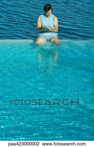 Man sitting in infinity pool, reading View Large Photo Image Stock Image - Man sitting in infinity pool, reading. Fotosearch
