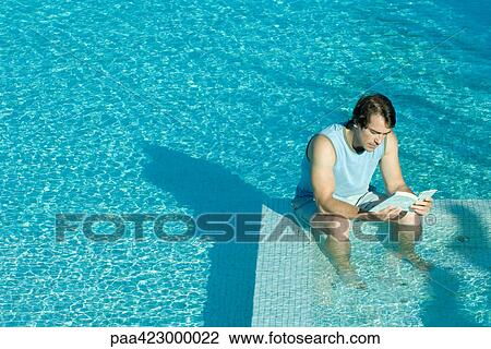 Man sitting in swimming pool, reading View Large Photo Image Stock Image - Man sitting in swimming pool, reading. Fotosearch