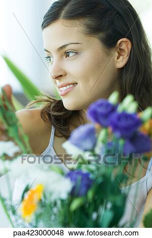 Young woman, flowers in foreground, portrait View Large Photo Image Stock Photo - Young woman, flowers in foreground, portrait. Fotosearch