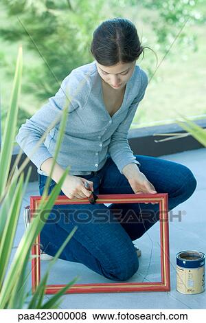 Young woman painting picture frame outdoors View Large Photo Image Stock Photo - Young woman painting picture frame outdoors. Fotosearch