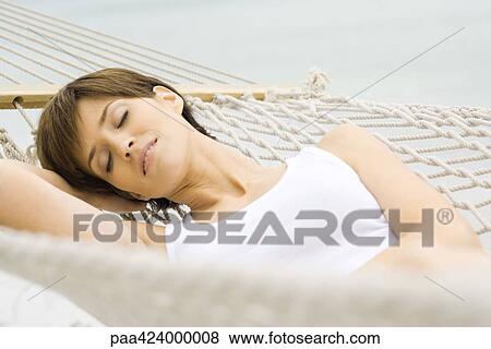 Woman relaxing on hammock View Large Photo Image Stock Photo - Woman relaxing on hammock. Fotosearch