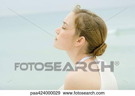 Young woman, head and shoulders, side view, sea in background View Large Photo Image Stock Photo - Young woman, head and shoulders, side view, sea in background. Fotosearch