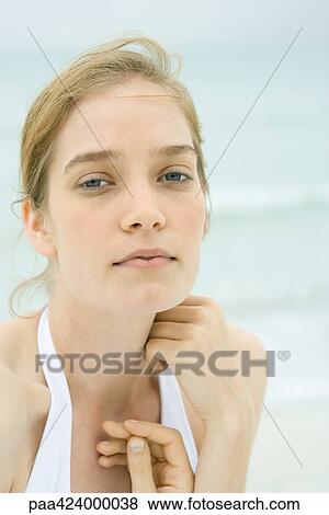 Young woman, head and shoulders, portrait, sea in background View Large Photo Image Stock Photo - Young woman, head and shoulders, portrait, sea in background. Fotosearch