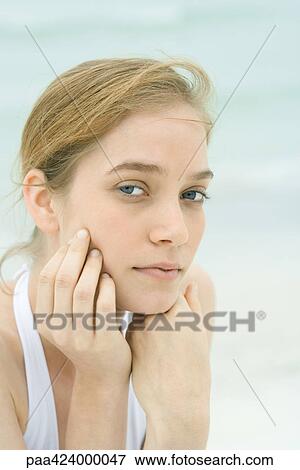 Young woman, head and shoulders, portrait, sea in background View Large Photo Image Stock Photo - Young woman, head and shoulders, portrait, sea in background. Fotosearch