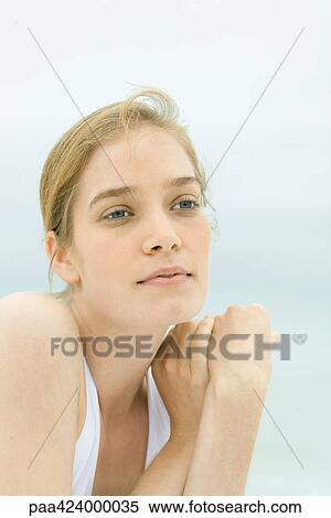 Young woman, head and shoulders, portrait, sea in background View Large Photo Image Stock Photography - Young woman, head and shoulders, portrait, sea in background. Fotosearch