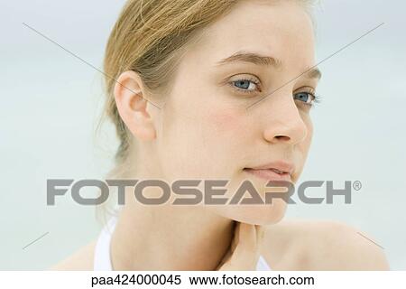 Stock Photography - Young woman, head and shoulders, portrait, sea in background. Fotosearch