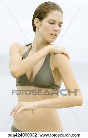 Young woman in bathing suit with hand on shoulder, waist up View Large Photo Image Stock Image - Young woman in bathing suit with hand on shoulder, waist up. Fotosearch