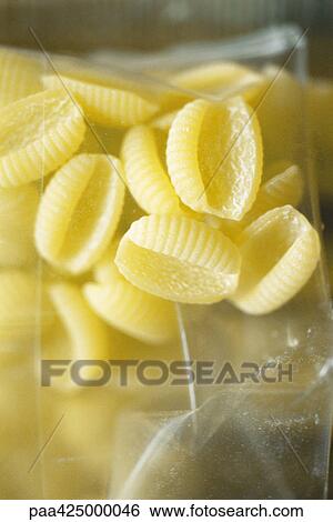 Stock Photograph - Gnocchi pasta in package, close-up. Fotosearch