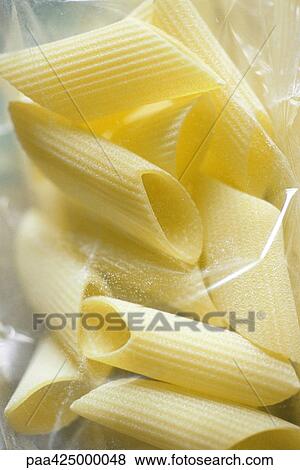 Penne pasta in package, close-up View Large Photo Image Stock Photo - Penne pasta in package, close-up. Fotosearch