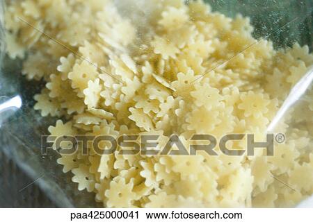 Stock Image - Stellette pasta in package, close-up. Fotosearch
