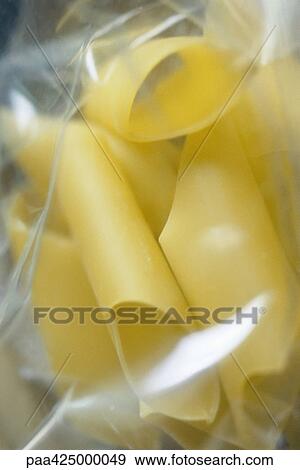 Stock Photo - Tufoli pasta in package, close-up. Fotosearch