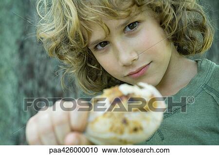 Boy holding up grilled chicken leg View Large Photo Image Stock Image - Boy holding up grilled chicken leg. Fotosearch
