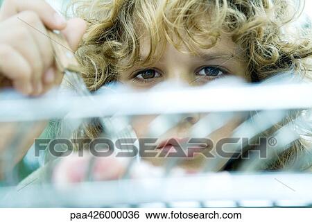 Boy looking over grill View Large Photo Image Stock Photograph - Boy looking over grill. Fotosearch