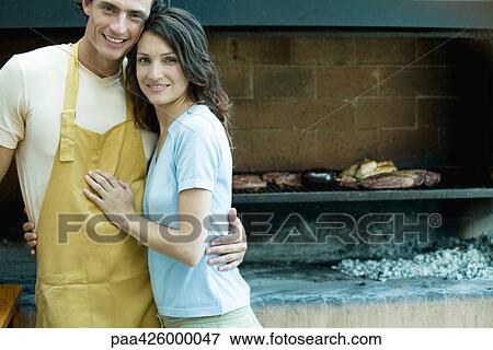Couple having cookout, smiling at camera View Large Photo Image Stock Photo - Couple having cookout, smiling at camera. Fotosearch