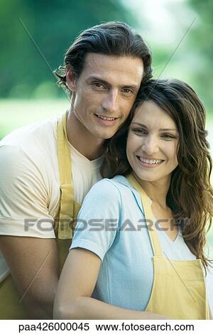 Couple wearing matching aprons, portrait View Large Photo Image Stock Photography - Couple wearing matching aprons, portrait. Fotosearch