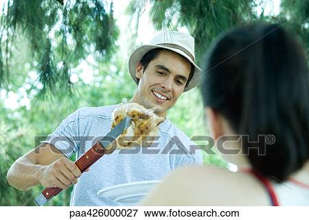 Man serving girl piece of grilled chicken View Large Photo Image Stock Photo - Man serving girl piece of grilled chicken. Fotosearch