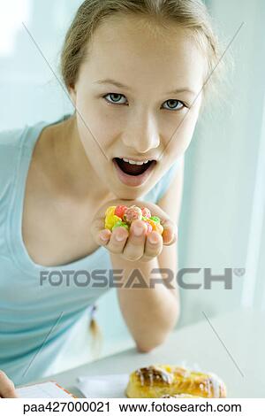 Stock Image - Girl eating junk food. Fotosearch