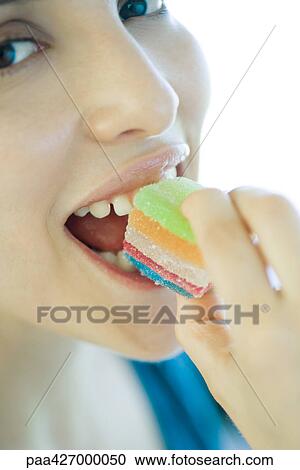 Woman eating candy, close-up of face View Large Photo Image Stock Image - Woman eating candy, close-up of face. Fotosearch
