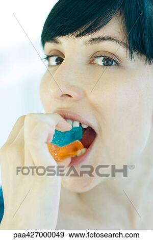 Woman eating candy View Large Photo Image Stock Photo - Woman eating candy. Fotosearch