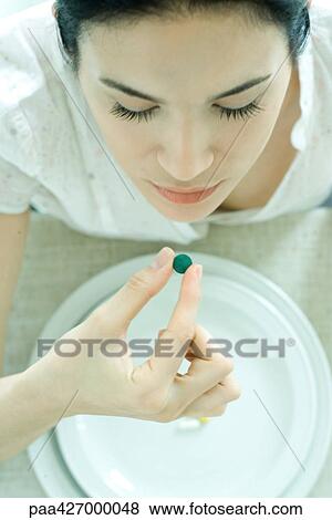 Woman taking vitamin View Large Photo Image Stock Photo - Woman taking vitamin. Fotosearch