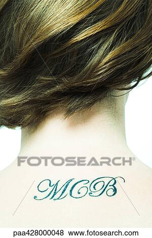 Initials tattooed on teenage girl's back View Large Photo Image Stock Photo - Initials tattooed on teenage girl's back. Fotosearch
