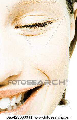Stock Image - Teenage girl's face, cropped front view. Fotosearch