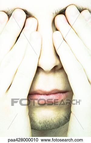 Young man covering eyes, extreme close-up View Large Photo Image Stock Image - Young man covering eyes, extreme close-up. Fotosearch