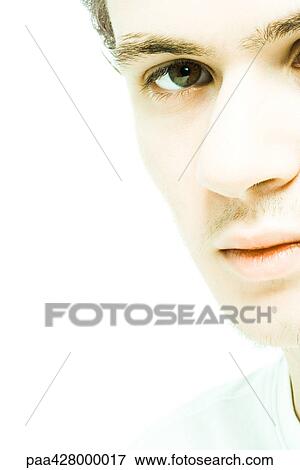Stock Photo - Young man, cropped view of face. Fotosearch