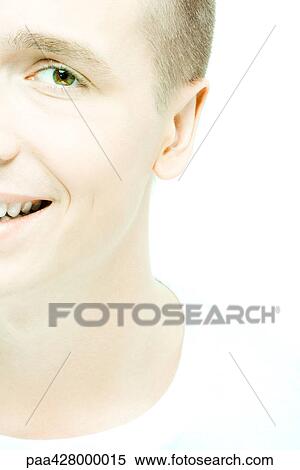 Stock Photography - Young man smiling at camera, close-up, cropped. Fotosearch