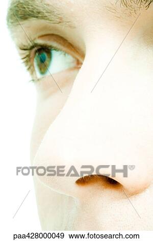 Stock Photo - Young man's face, extreme close-up, cropped view. Fotosearch