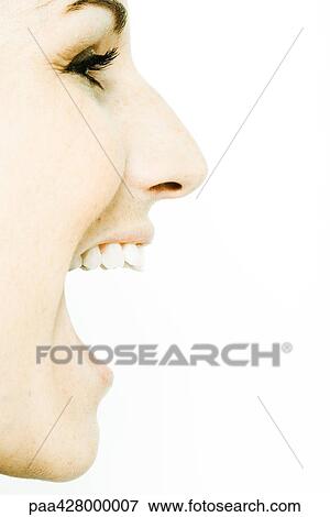 Stock Photo - Young woman's face with mouth wide open, profile. Fotosearch