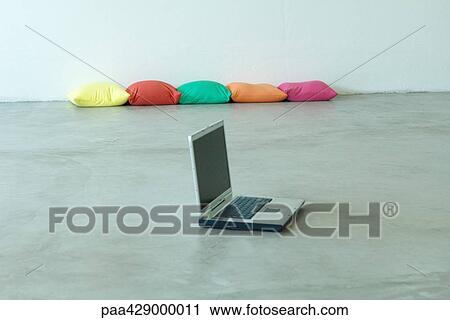 Open laptop on floor, cushions in background View Large Photo Image Stock Image - Open laptop on floor, cushions in background. Fotosearch