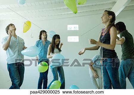 Teenage friends playing with balloons View Large Photo Image Stock Photography - Teenage friends playing with balloons. Fotosearch