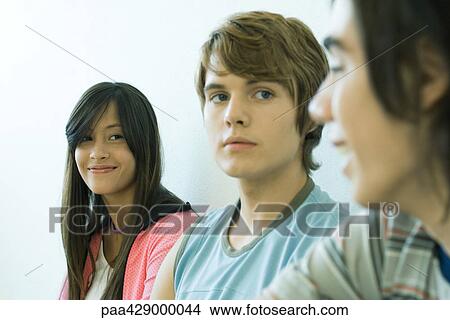 Teenage friends smiling at each other View Large Photo Image Picture - Teenage friends smiling at each other. Fotosearch