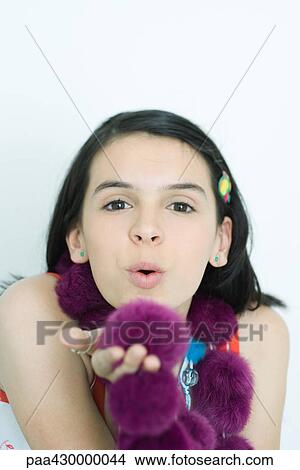 Teenage girl blowing kiss at camera, portrait View Large Photo Image Picture - Teenage girl blowing kiss at camera, portrait. Fotosearch