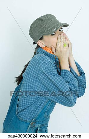 Teenage girl covering lower face with hands, portrait View Large Photo Image Picture - Teenage girl covering lower face with hands, portrait. Fotosearch