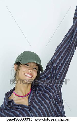 Teenage girl, one arm in the air, smiling at camera, portrait View Large Photo Image Stock Photography - Teenage girl, one arm in the air, smiling at camera, portrait. Fotosearch