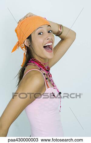 Teenage girl, smiling at camera with mouth wide open and hand on head, portrait View Large Photo Image Stock Image - Teenage girl, smiling at camera with mouth wide open and hand on head, portrait. Fotosearch