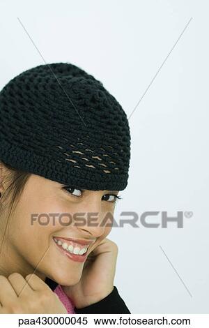 Stock Photography - Teenage girl wearing knit hat, portrait. Fotosearch