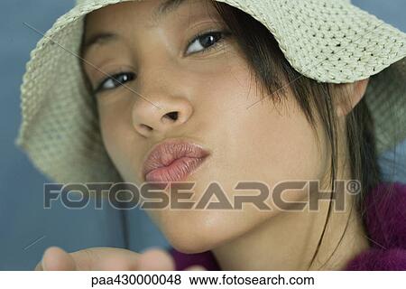 Teenage girl wearing sun hat, puckering lips, portrait View Large Photo Image Stock Photo - Teenage girl wearing sun hat, puckering lips, portrait. Fotosearch
