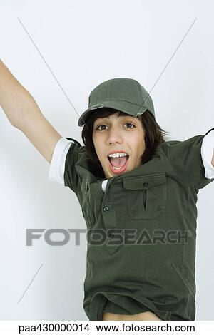 Picture - Teenage shouting with arms in the air, portrait. Fotosearch