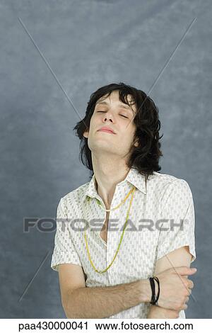 Stock Image - Young man, head back and eyes closed, portrait. Fotosearch